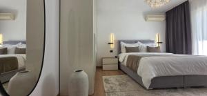 a bedroom with a large bed and a mirror at Guesthouse Čivljak in Baška Voda