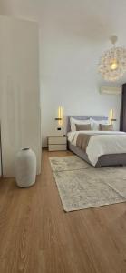 a bedroom with a bed and a chandelier at Guesthouse Čivljak in Baška Voda +69 photos