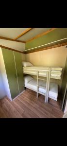 a small room with two bunk beds in it at Chalet en Corse in Santa-Maria-Figaniella