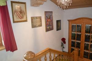 a room with a staircase with pictures on the wall at Ferienhaus am Lechweg in Steeg