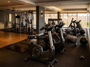 a gym with several exercise bikes in a room at Beach, Restaurants, Shopping, Park, Pier - nearby in Durban