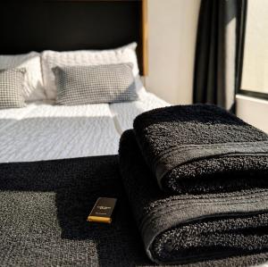 a bed with a remote control sitting on top of it at Beach, Restaurants, Shopping, Park, Pier - nearby in Durban +12 photos