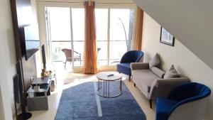 a living room with a couch and chairs and a table at Luxury Chalet Villa in Shimla