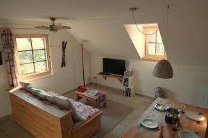 a living room with a couch and a table at Gîte La Grange in Chapelle