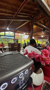 a man sitting at a table with a laptop at The Ci Dwi resort in Cicadas