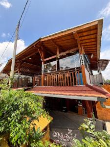 a house with a large balcony on top of it at The Ci Dwi resort in Cicadas
