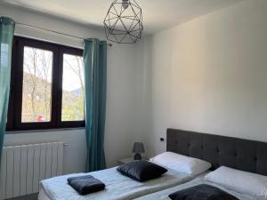 a bedroom with two beds and a window at Appartamento sole e luna in Dumenza
