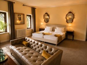 a large bedroom with a bed and a couch at Romantik Hotel Schloss Reichenow in Reichenow +47 photos