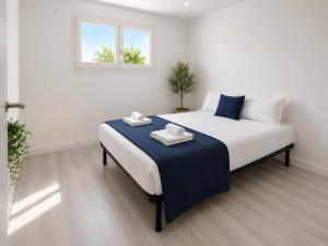 a bedroom with a bed with two towels on it at VILLA PARADISE SILVIA in Sant Pere de Ribes +29 photos