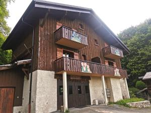 a large wooden building with two balconies on it at Chalet Le Refuge in Samoëns