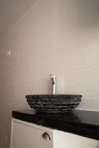 a bathroom with a stone sink on a counter at D. Antonia in Peniche