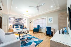 a hotel room with a bed and a table and chairs at Le Seasons Resort in Candolim
