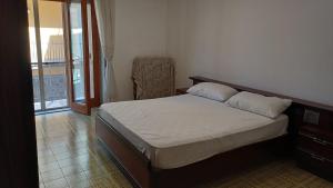 a bedroom with a bed in a room with a balcony at Casa Carmela in Sapri