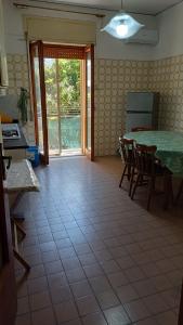 a kitchen with a table and chairs in a room at Casa Carmela in Sapri