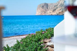 a glass of wine with a view of the ocean at Fodele Beachfront Apts in Fodele +33 photos