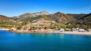 a view of a beach with mountains in the background at Fodele Beachfront Apts in Fodele