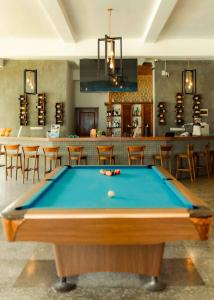 a pool table in a room with a bar at Uppuveli Beach by DSK in Trincomalee