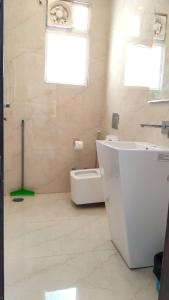a white bathroom with a sink and a toilet at Luxury Chalet Villa in Shimla +48 photos