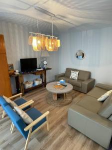 a living room with a couch and a table at Châtelaines 59 in Avallon