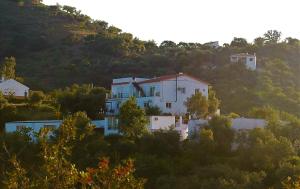 a house on top of a hill with trees at Jingtu Wellness & Spa Resort in Comares