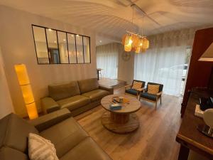 a living room with a couch and a table at Châtelaines 59 in Avallon