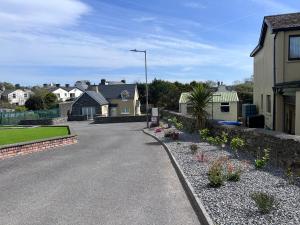 a street in a residential neighborhood with houses and flowers at 5 Bank House in Schull