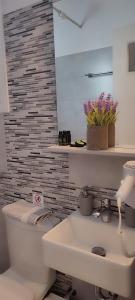 a bathroom with a white toilet and a sink at Maria Studios in Parikia +111 photos