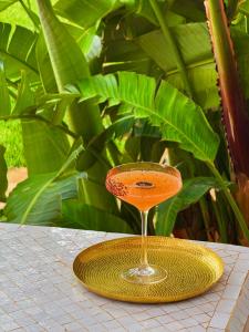 a cocktail glass on a yellow plate on a table at Maison Kenoosha Boutique Hotel & Spa in Marrakesh