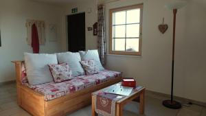 a living room with a couch and a table at Gîte La Grange in Chapelle