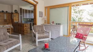 a living room with two chairs and a glass table at Chalet authentique à Ovronnaz in Leytron