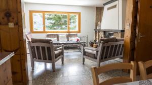 a living room with two chairs and a table at Chalet authentique à Ovronnaz in Leytron