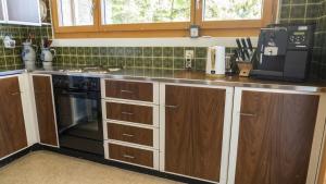a kitchen with a stove and a microwave at Chalet authentique à Ovronnaz in Leytron +19 photos