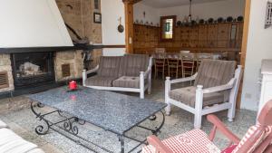 a living room with a table and chairs and a fireplace at Chalet authentique à Ovronnaz in Leytron