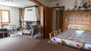 a dining room with a table and a fireplace at Chalet authentique à Ovronnaz in Leytron