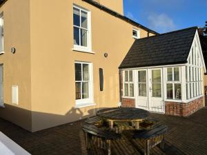 a patio with a table and chairs in front of a building at 5 Bank House in Schull +15 photos