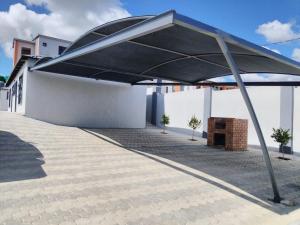 a large black umbrella on the side of a building at Phumlani Village Lodge in White River