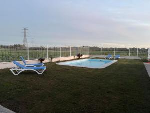 a swimming pool with a lounge chair and a pool at Los Granainos in Arcos de la Frontera
