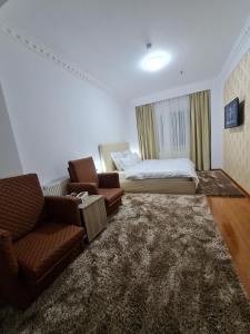 a bedroom with a bed and a couch and chairs at Casa cu pastravi in Sinaia +35 photos