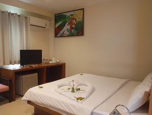 a hospital room with a bed with flowers on it at Sea Star House in Ao Nang Beach