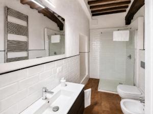 a white bathroom with a sink and a toilet at Dimora storica - Palazzo Barabesi in Siena +22 photos