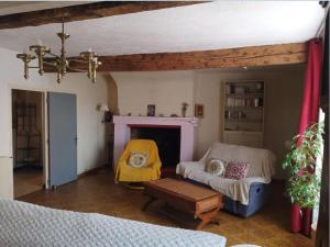 a living room with a couch and a fireplace at Maison de village commingeoise in Miramont-de-Comminges +2 photos