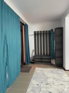 a room with blue curtains and a tile floor at Laguna City Lux in Tegirmenty