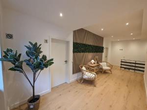 a living room with a table and chairs and a plant at HarmoNest 1 Mgladbach South in Mönchengladbach