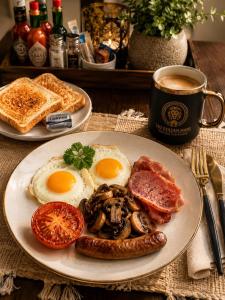 a plate of breakfast food with eggs sausage and toast at Tau Golden Mane in Johannesburg