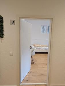 a door leading into a room with a bed at HarmoNest 2 Mgladbach south in Mönchengladbach