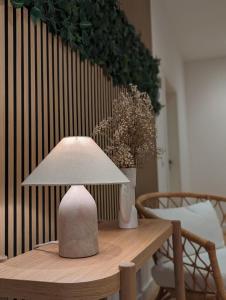 a lamp sitting on top of a wooden table at HarmoNest 2 Mgladbach south in Mönchengladbach +15 photos