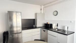 a kitchen with a stainless steel refrigerator and a sink at Domek 80m2 na wyłączność in Tczew