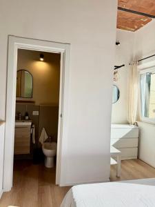 a white bathroom with a sink and a toilet at Casetta di Dodo - Charm Toscano in Centro in Collesalvetti +23 photos