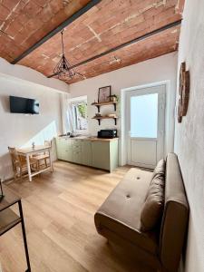 a living room with a couch and a table at Casetta di Dodo - Charm Toscano in Centro in Collesalvetti
