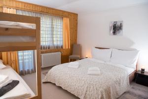 a bedroom with a bed with two towels on it at Ski in Ski out Family accommodation Chesa Katja Lenzerheide in Valbella
